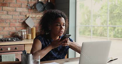 Focused millennial woman work from home using modern tech gadgets