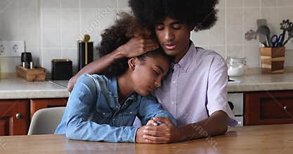 Older brother calming younger sister, hugs, express sympathy, give support