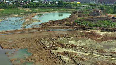 Drained lake as viewed by dron. Aerial view of drainage of the construction site. Cleaning the bottom of the lake from
