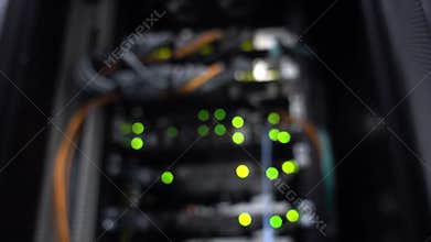 Blurred onnecting computers together. Working Ethernet server. There is a small noise. RJ45 jacks blinking LED lights