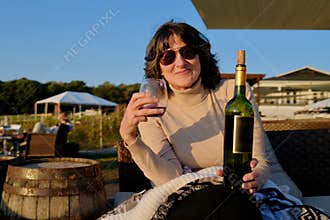 Happy Woman Enjoying Glass of Wine Outdoors