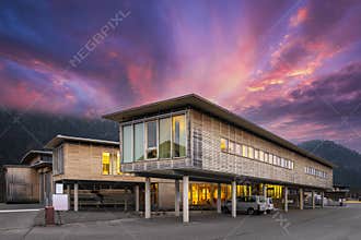 Sustainable wood office building on pillars with parking spaces underneath