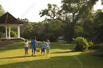 Family walking in park.