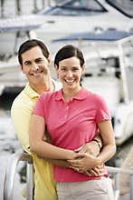 Couple embracing at harbor.