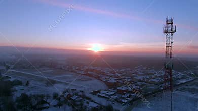 Aerial view panoramic landscape of cell towers at dawn in winter.