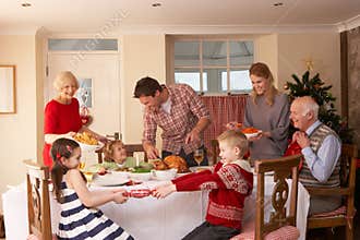 Family serving Christmas dinner
