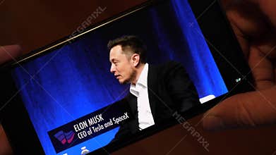 USA - 15 July 2017: Elon Musk Interview about Future. Watching the Video on a Smartphone