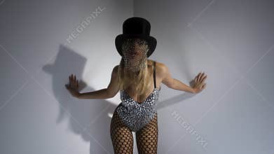 Young woman wearing top hat with sparkly veil and bustier