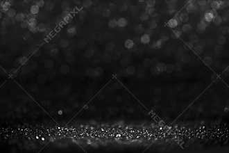 Black friday bokeh background. Elegant dark blur layout design. Silver and black glitter place on table with spotlight. Luxury