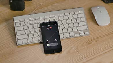 Editorial footage: Smartphone with incoming mum call. Smart phone vibrates, bounces and flies up from the table. Mobile