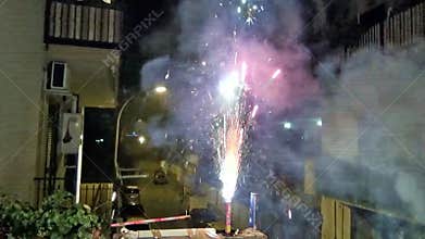 A person lighting fireworks to celebrate New Year’s Eve.