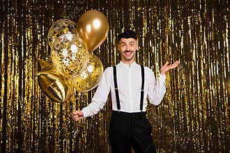 Photo of young excited man happy positive smile surprised hold air balloons birthday party isolated over shine color