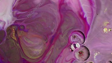 Alcoholic inks in shades of rosy lilac blend and move slowly