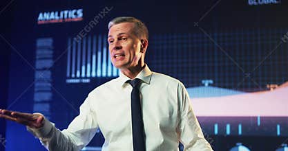 Mature male speaker encouraging audience during business training
