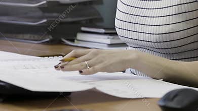 Businesswoman signing a contracts, legal agreements, papers. Action. Close up of business woman hands and documents