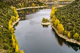 Autumn landscape, canyoned river with green, yellow trees. Hoces Duraton River