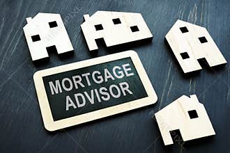 Mortgage advisor on the dark wooden plate.
