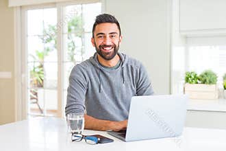 Man smiling working using computer laptop