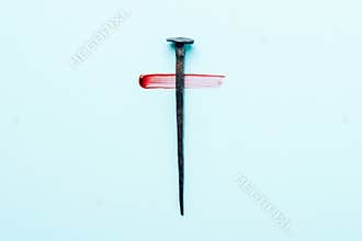 Christian cross made with rusty nails, drops of blood on blue background. Copy space. Good Friday, Easter day. Christian