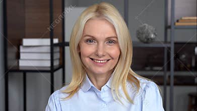 Smiling confident middle aged business woman looks at camera, portrait.