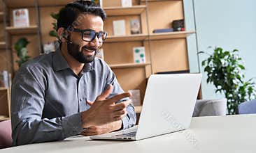 Happy indian business man remote teacher giving distance learning class.