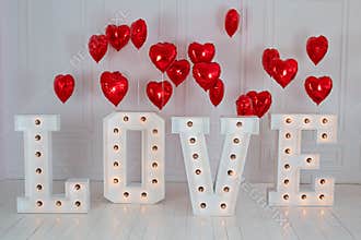 Love big letters with led retro bulbs glowing. Word LOVE illuminated with a big letters. Inscription is love. Glowing large letter