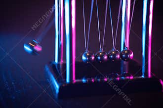 Newton cradle. Demonstrating gravity, action and reaction principle in physics.