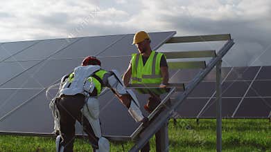 Male engineer delivering solar cell to colleague