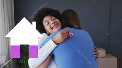 Animation of house icon filling pink, over happy couple with house keys embracing