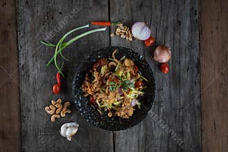 Top view of Somtam Papaya Salad with pork crackling