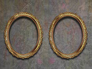 Two guilded frames on old wallpaper