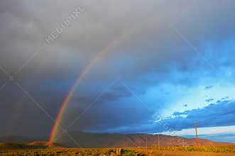 Double Rainbow Over Desert Landscape