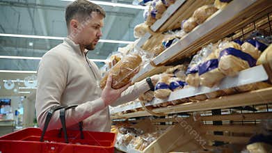 aisle with bread in supermarket, man is shopping alone in grocery
