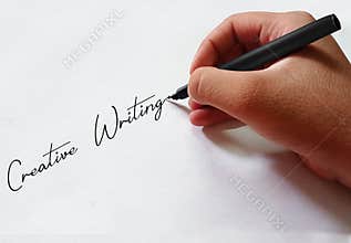 Creative Writing Background with Hand is writing with pen on the paper. Modern copyrighting backdrop