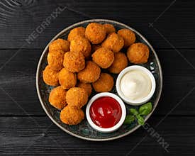 Meat free vegetarian mini picnic scotch eggs with micoprotein and herbs served with ketchup and mayonnaise