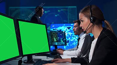 Workplace of the air traffic controllers in the control tower. Diverse team of professional aircraft control officers