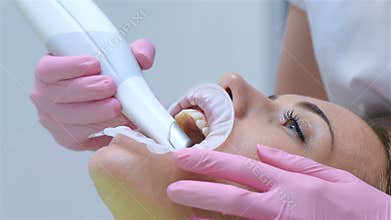 Orthodontist scanning patient`s teeth with dental intraoral scanner.
