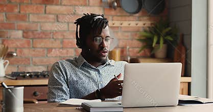 African guy communicate through video conference app on laptop