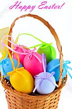 Easter colored eggs in the basket. Happy Easter!