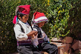A Peruvian boy knits with 4 needles.