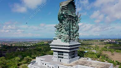 Aerial view statue hindu god garuda wisnu kencana Statue, Bali. The sightseeing Helicopter flies past the GWK statue