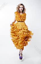 Lovely woman blonde fashion model in yellow dress