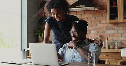 Happy African couple check email read fantastic news celebrate success