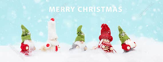 Little cute girls and christmas elves standing in the snow, festive greeting card, copy space