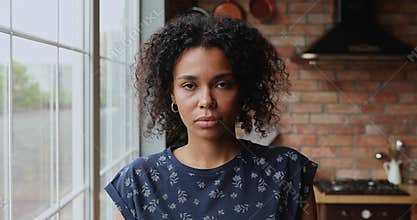 Headshot portrait sad 30s African woman staring at camera