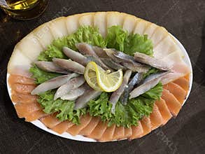 Assorted fish cuts. snack on a white plate