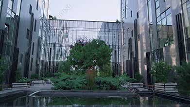 Modern glass building exterior. Panorama windows reflecting clear sky in morning