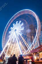 Illuminations of the big wheel at the christmas market on the main place