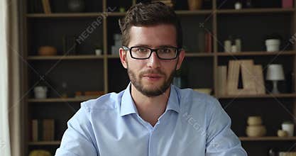 Webcam view young man wave hand start talk by videocall