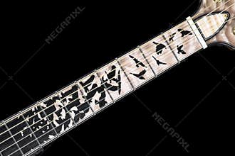 Significant example of woodworking artistry - ebony bird inlay on flamed maple guitar fretboard